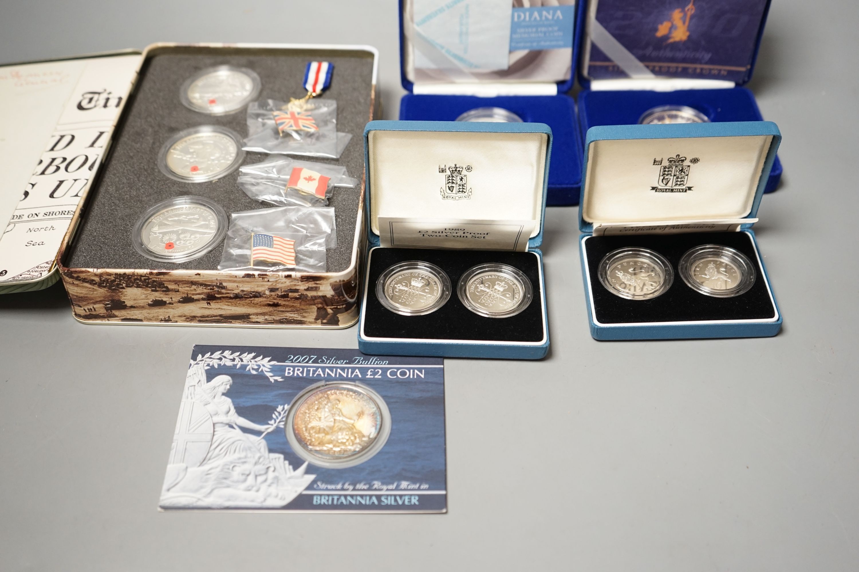 Cased Royal Mint UK proof coins – a Diana Memorial silver coin, a Millennium £5, a D-day 3 coin silver medal set, a 1992 two coin 10p set and a 1989 two coin £2 set